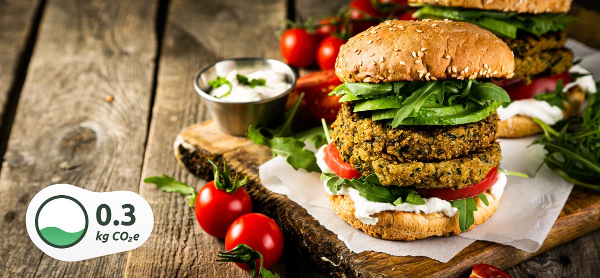Vegan zucchini burger and ingredients on rustic wood background